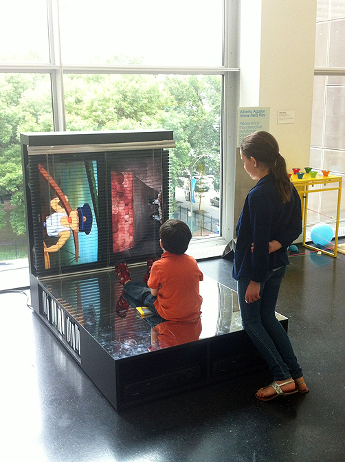 Alberto Aguilar, Visitors watching Obscure Time Device (Home Field Play) at MCA Chicago, 2013, Digital image