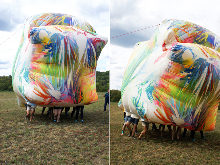 Claire Ashley, Documentation of performance “Ruddy Udder Dance” 2012, in collaboration with The Happy Collaborationists and ten resident artists at ACRE, Steuben, WI. Spray paint on PVC coated canvas tarpaulin and fan. Photo courtesy of the artist.