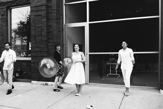 Members of Brave New Art World throwing around big huge bouncy balls for Rhona Hoffman's exhibition closing, August 2013