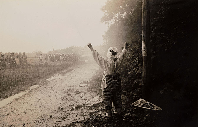 Kazuo Kitai. Female Farmer Taking a Stand against the Riot Police Water Cannon from Riot Police from the series Sanrizuka, 1970. The Art Institute of Chicago, Kenneth and Christine Tanaka and Photography Purchase Funds. © 1970 Kazuo Kitai.