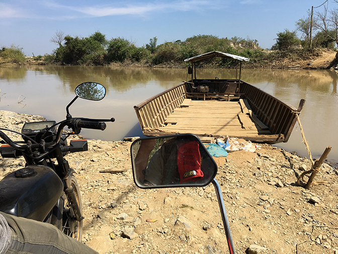 Garrett and Mike Paro waiting for a ferry far into the Vietnamese highlands