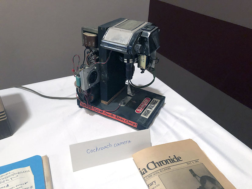 Jno Cook's Cockroach Camera with news articles, Chicago, 2019