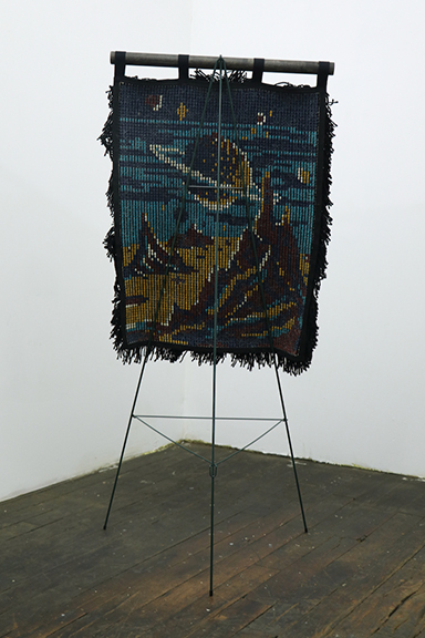 Jeffrey Grauel, Shagged Retrograde, antiquated pattern, acrylic yarn, wood dowel, funerary wreath easel, 52 x 24 x 19 inches, 2018