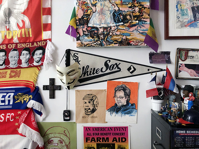 Some flags, artworks, and drawings by friends and students with a Chicago White Sox's pennant.