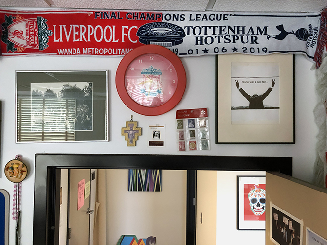 The Liverpool FC Tottenham Hotspurs scarf from the 2019 Champions League Final in Madrid, Spain are flanked by a photograph of the university's ground breaking in 1920 and other oddities.